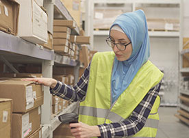 Learn more about inventory and inactive records Image. Staff scanning boxes